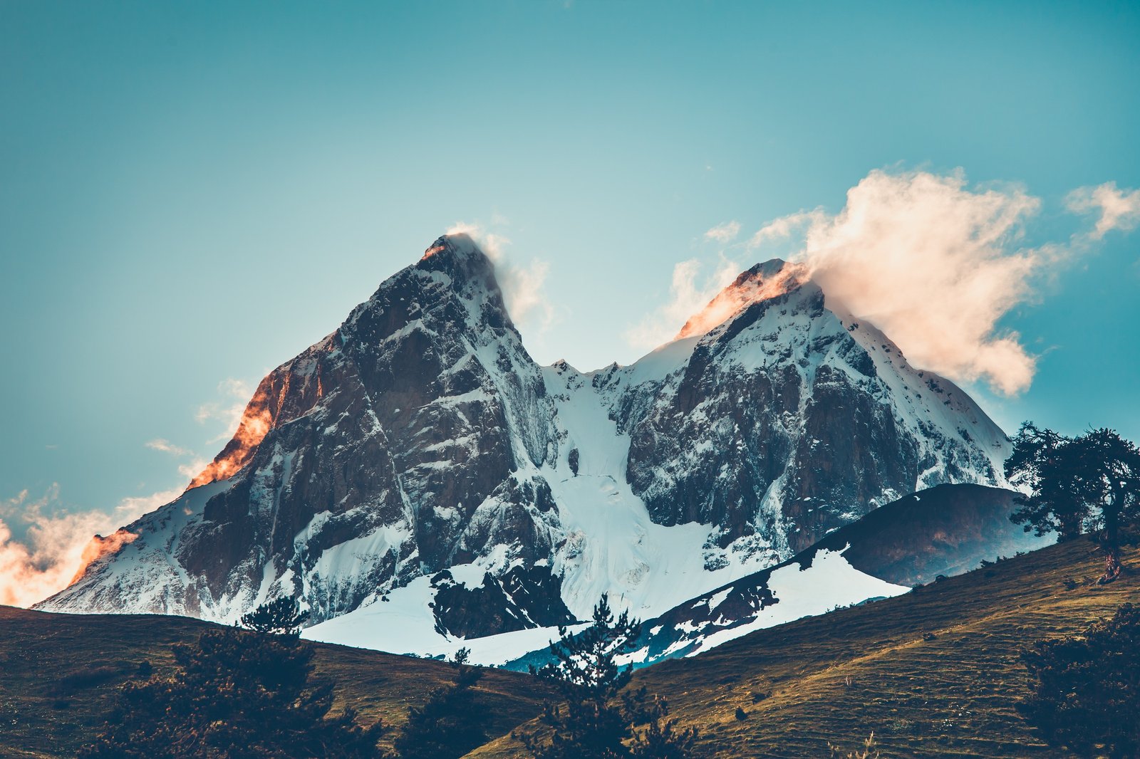 Sunset evening view over the snowy mountain peak